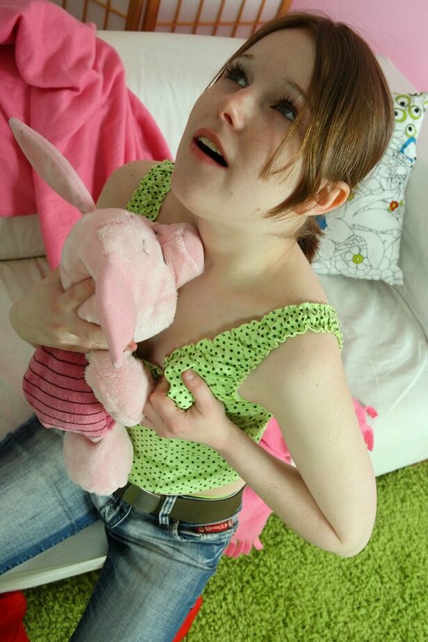 16P Sweet young girl Angela uncovers her tiny tits while playing with a plush toy