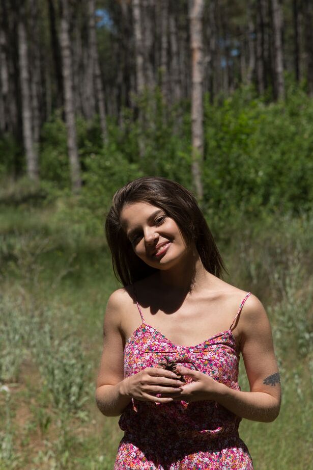 16P Nice teen Pola holds a pine cone while modeling totally naked in the woods