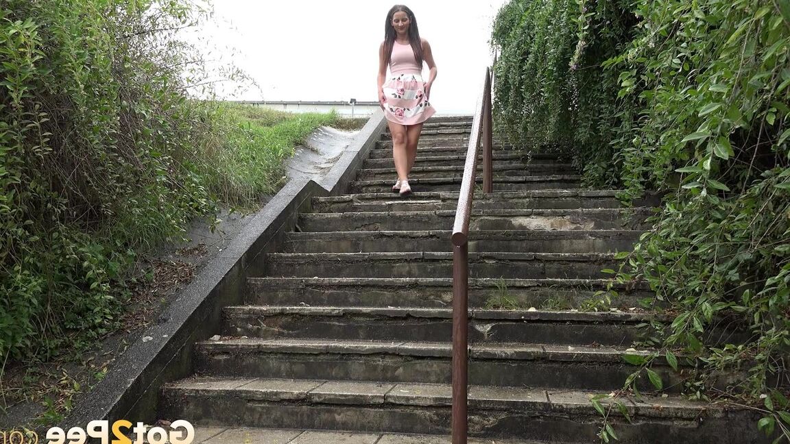 15P Caucasian teen Nicolette Noir pees while descending a flight of public stairs