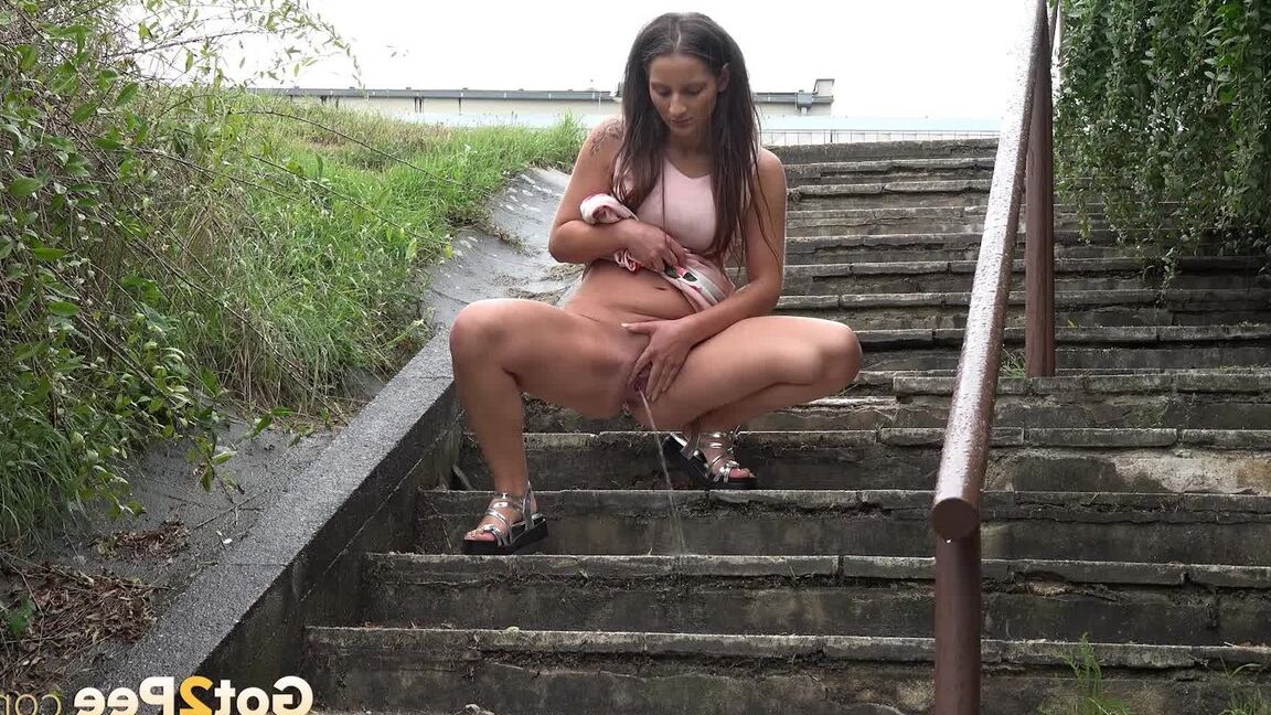 15P Caucasian teen Nicolette Noir pees while descending a flight of public stairs