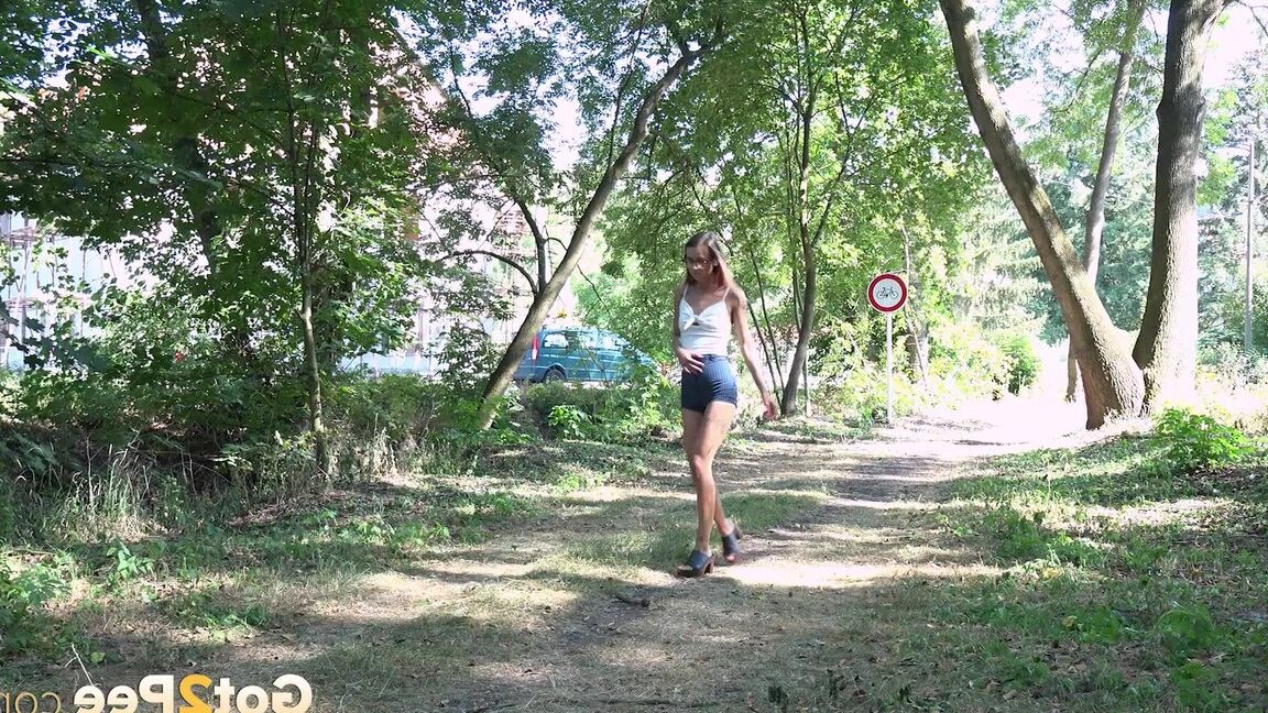15P Cute babe squats to piss next to a road on grass
