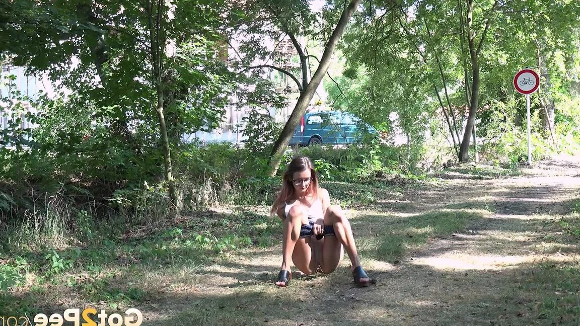 15P Cute babe squats to piss next to a road on grass