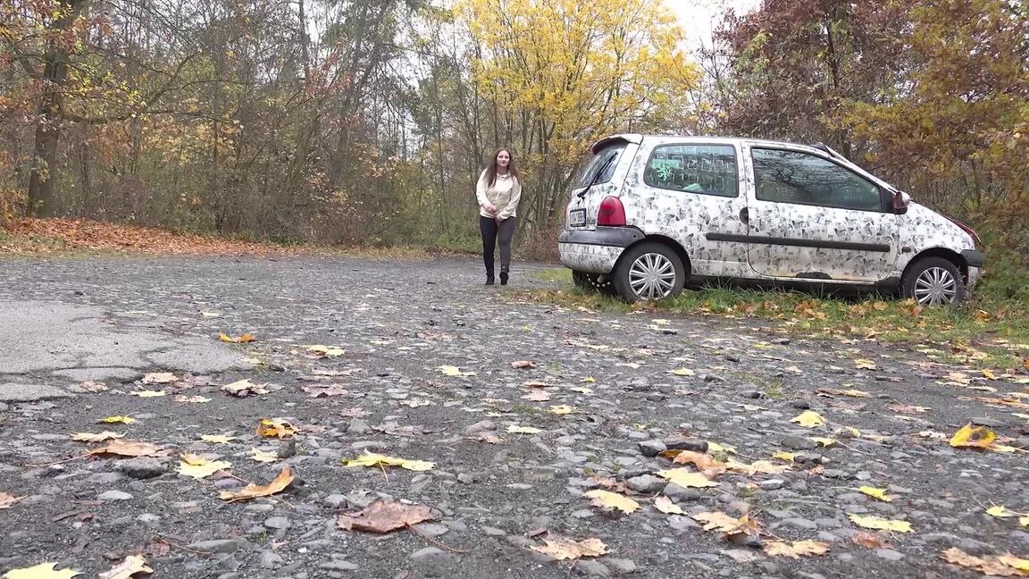 15P White girl Nicolette Noir takes a piss beside a parked car in a wooded setting