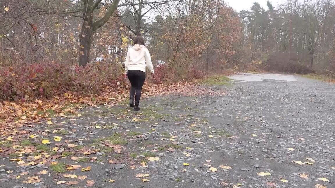 15P White girl Nicolette Noir takes a piss beside a parked car in a wooded setting