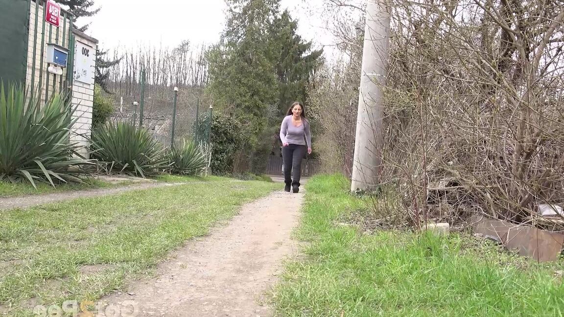15P Nicolette Noir takes a piss while walking on a dirt path behind some homes