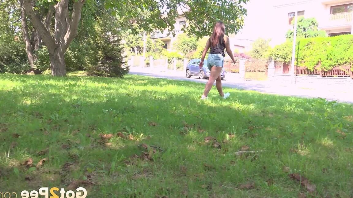 15P Nicolette Noir pees near some houses outside