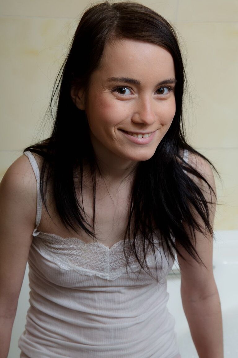 15P Thin brunette teen Delphina dildos her wet pussy while taking a bath