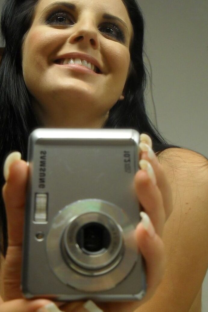 21P Sweet black haired babe Tara Tattoo strips and poses in front of a mirror