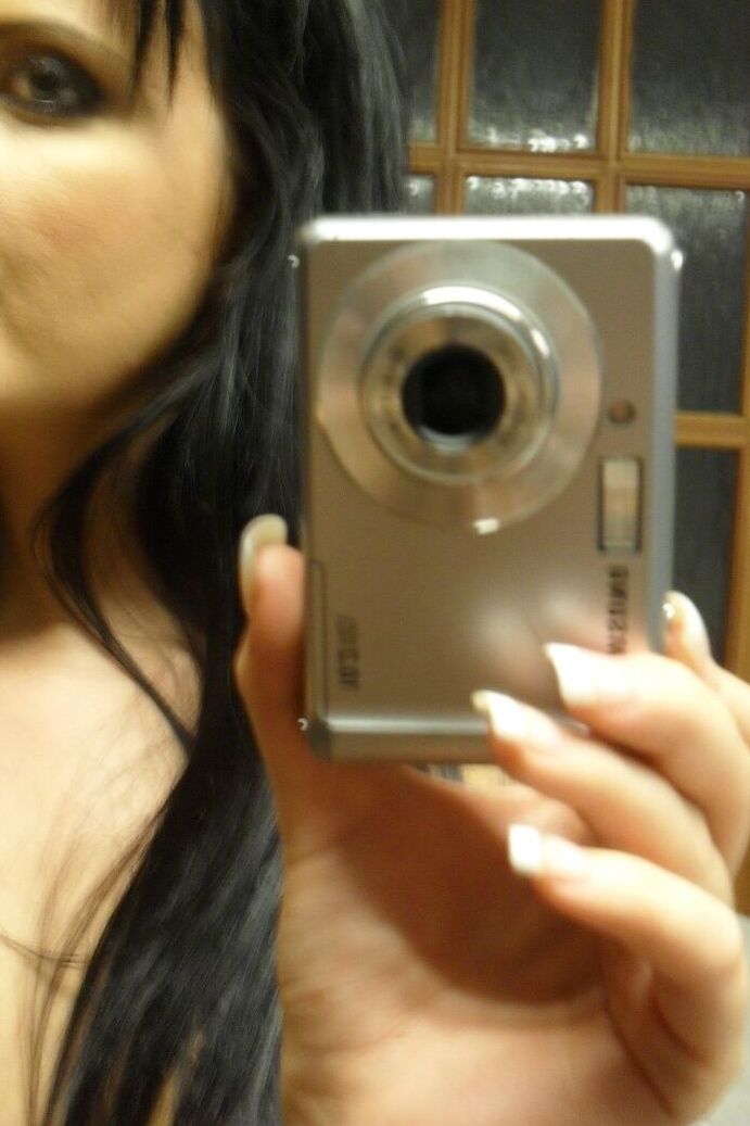 21P Sweet black haired babe Tara Tattoo strips and poses in front of a mirror