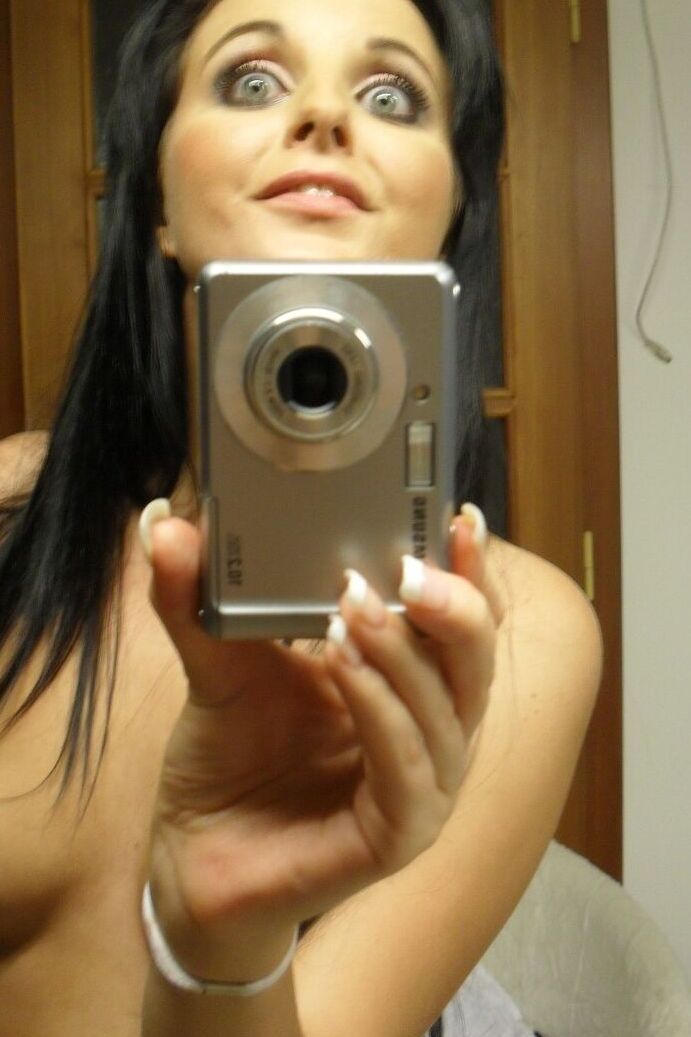 21P Sweet black haired babe Tara Tattoo strips and poses in front of a mirror