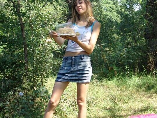 10P Young amateur eats a cake near the woods while wearing a denim miniskirt