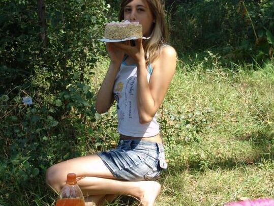 10P Young amateur eats a cake near the woods while wearing a denim miniskirt