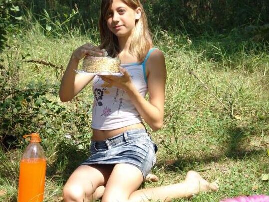 10P Young amateur eats a cake near the woods while wearing a denim miniskirt