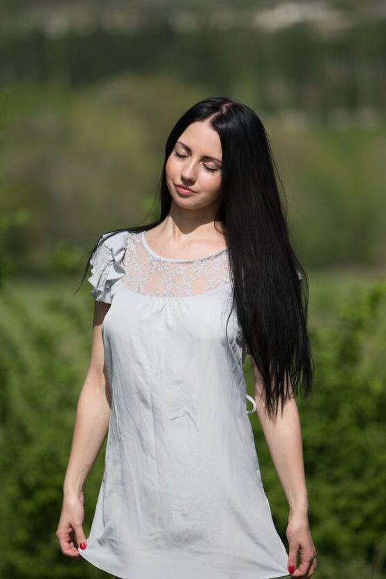 16P Veronica Snezna, une adolescente aux cheveux noirs, enlève sa robe pour poser nue sur un terrain surélevé.