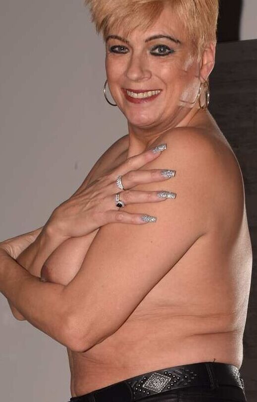19P Middle-aged amateur Dimonty models topless afore a mirror in leather pants