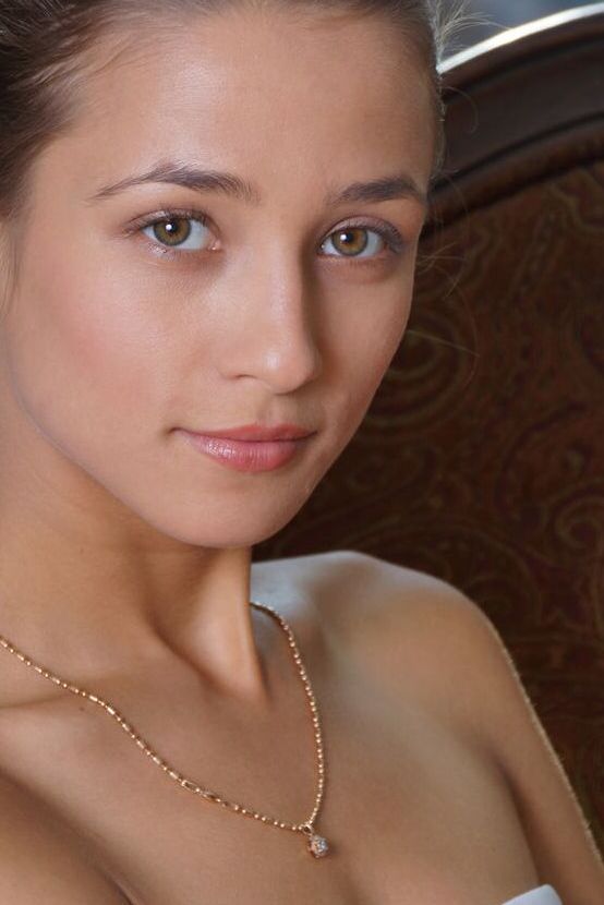 Das 18-jährige Teenie-Model Layna macht selbstbewusste Nacktposen mit den Händen in den schlanken Hüften