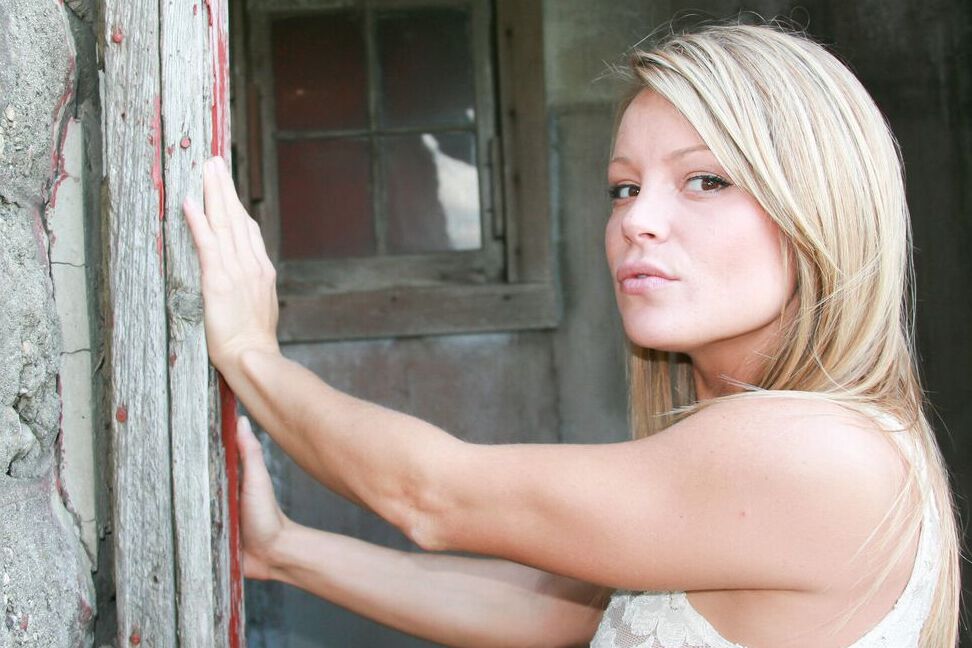 15P Blonde amateur Meet Madden casts sultry looks while posing in a lace thong