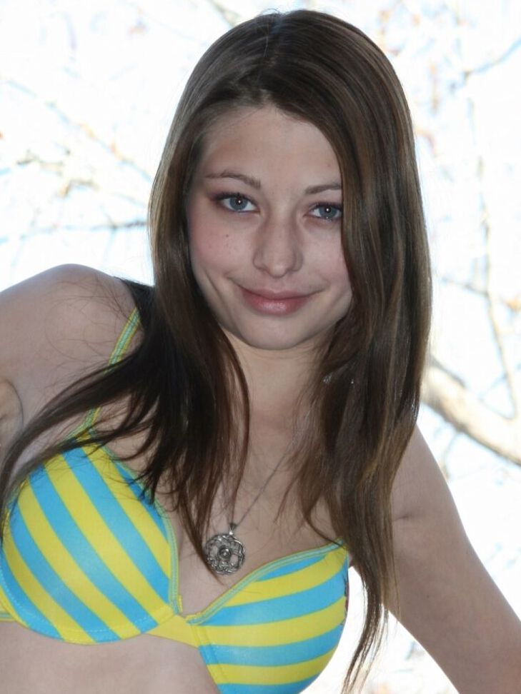 15P Amateur girl models a bra and panty ensemble on a condo balcony