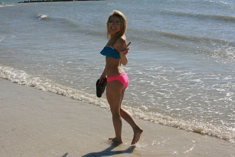 15P Blond amateur Meet Madden goes for a walk on the beach and boardwalk in bikini