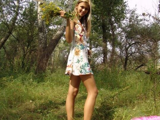 15P Teen amateur holds a bunch of wild flowers while getting naked by some trees