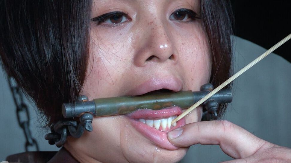 14P Submissive Asian girl Milcah Halili tests her pain threshold in a dungeon