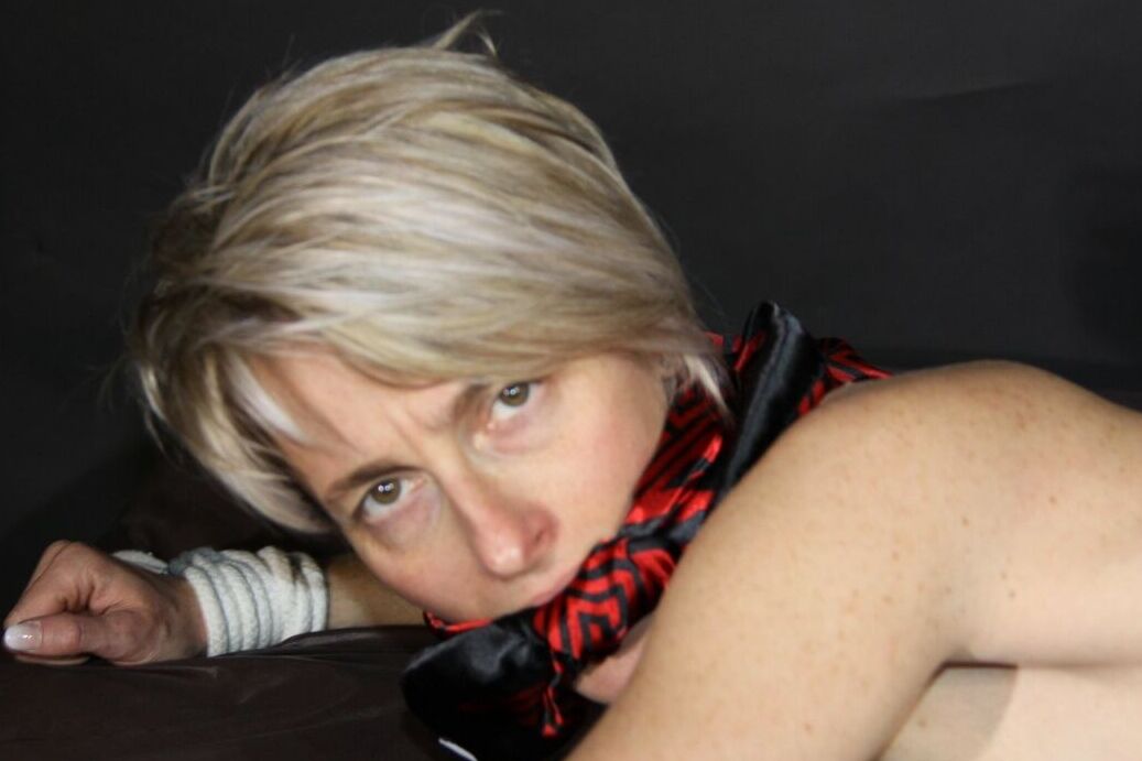 16P Blonde amateur Sonja is gagged and tied to a bed in a pair of shorts