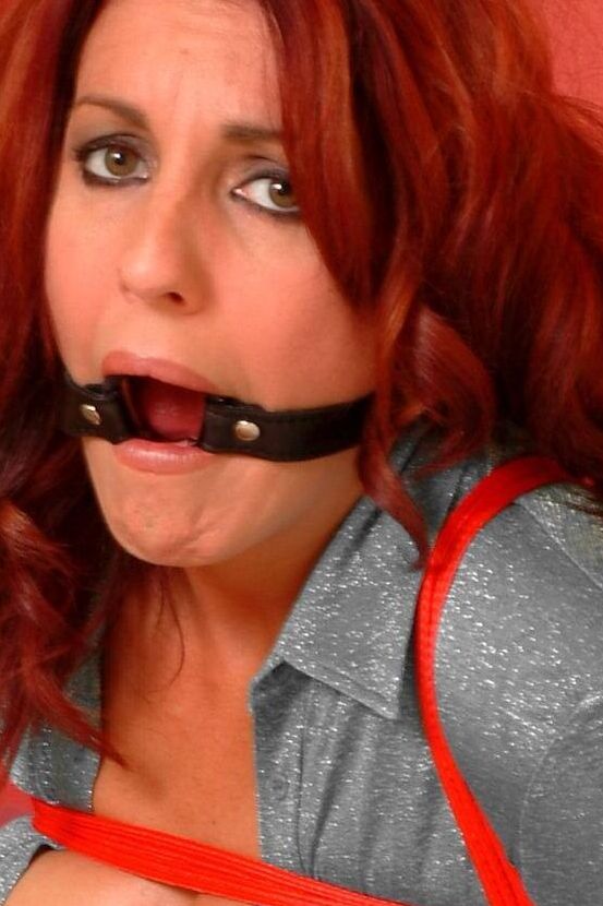 16P Redhead female spends her days gagged and bound in one way or another