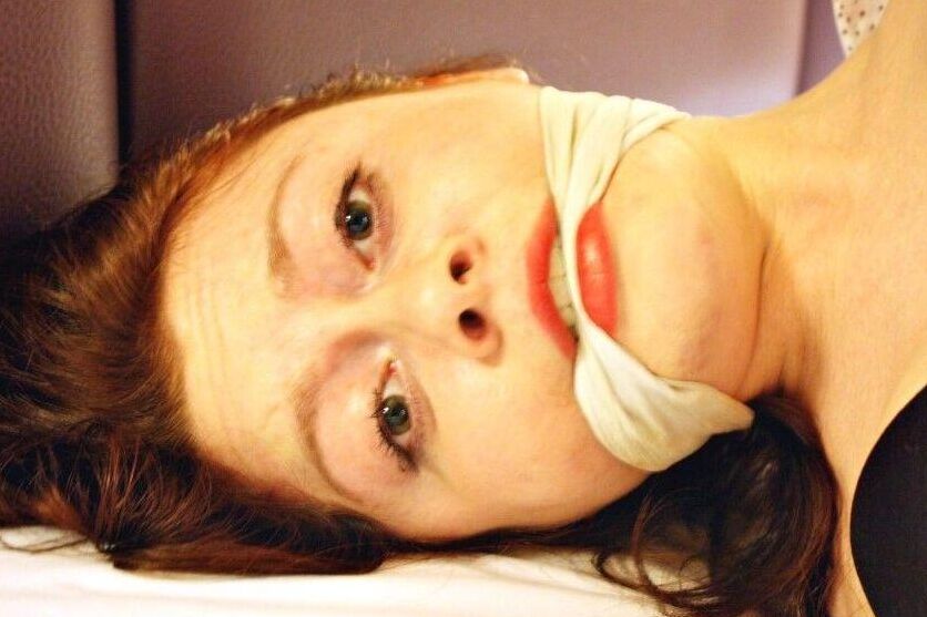 16P Natural redhead ends up cleave gagged while hogtied in her clothes on a bed
