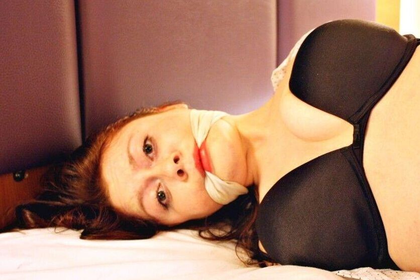 16P Natural redhead ends up cleave gagged while hogtied in her clothes on a bed