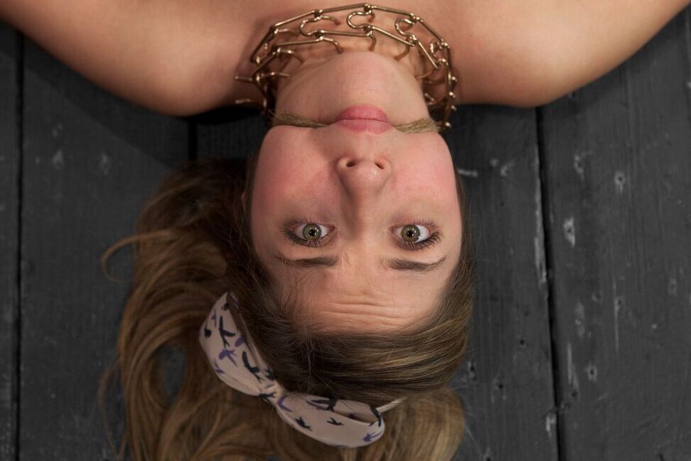 17P White chick Lia Lor is held in place by stocks and masturbated at will