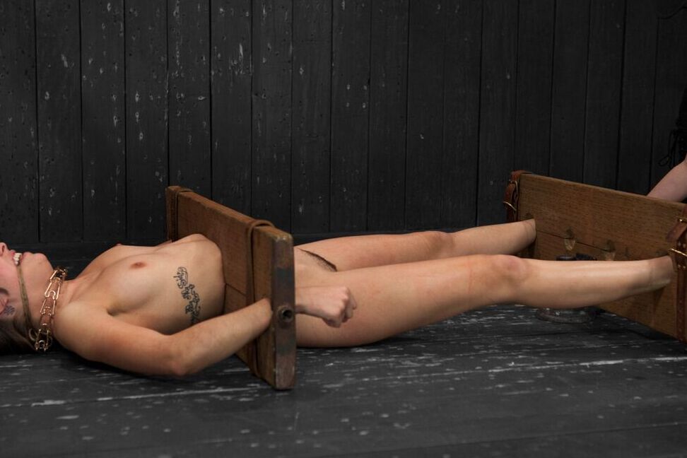 17P White chick Lia Lor is held in place by stocks and masturbated at will