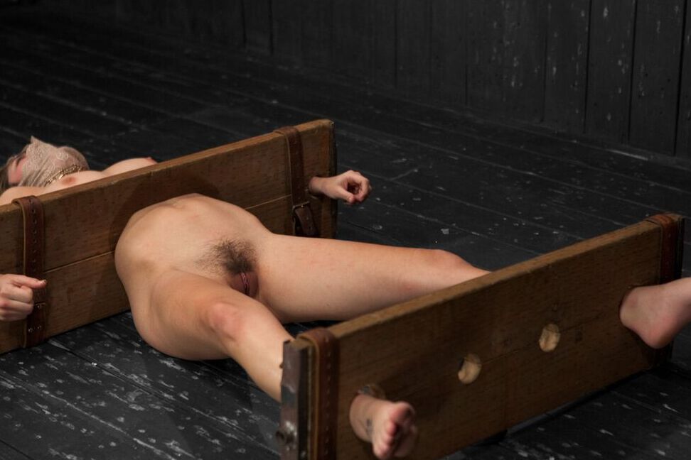 17P White chick Lia Lor is held in place by stocks and masturbated at will