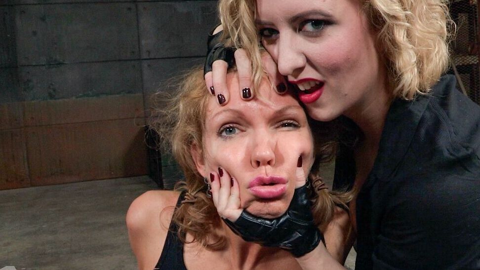 15P Busty blonde Rain Degrey is thoroughly debased by a female in a dungeon