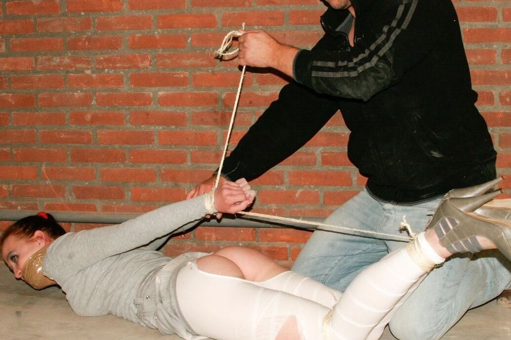 17P Bound and gagged white female has her white legging ripped open