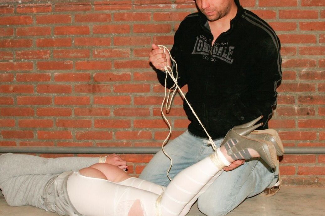 17P Bound and gagged white female has her white legging ripped open