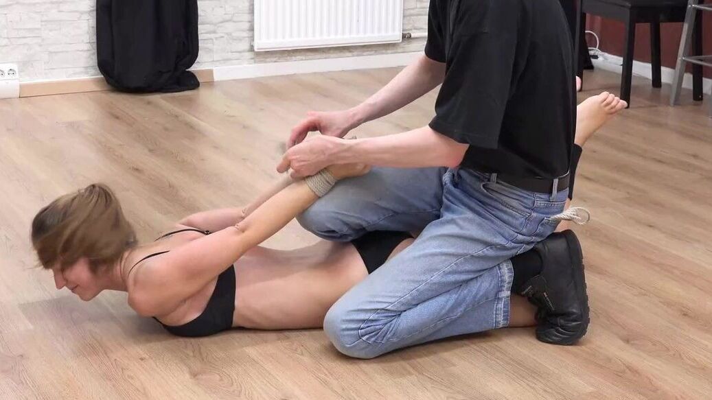 16P Bikini model finds herself tied up and hung from the rafters by her ankles