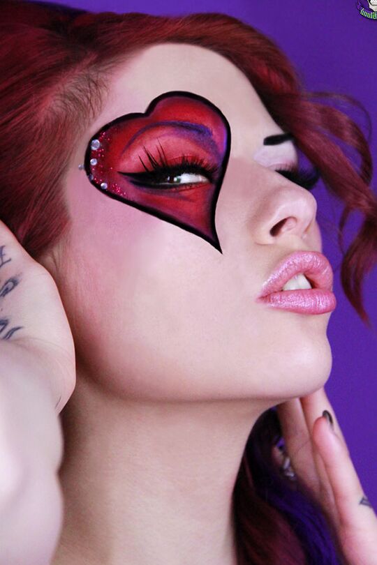 15P Beautiful redhead Vera Baby models naked in mismatched latex stockings