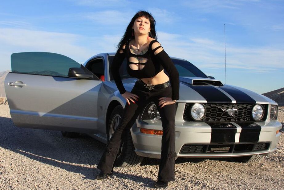 20P Brunette amateur Susy Rocks models by a muscle car during a safe for work gig