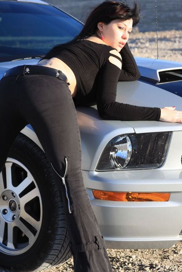 20P Brunette amateur Susy Rocks models by a muscle car during a safe for work gig