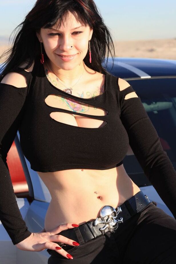 20P Brunette amateur Susy Rocks models by a muscle car during a safe for work gig