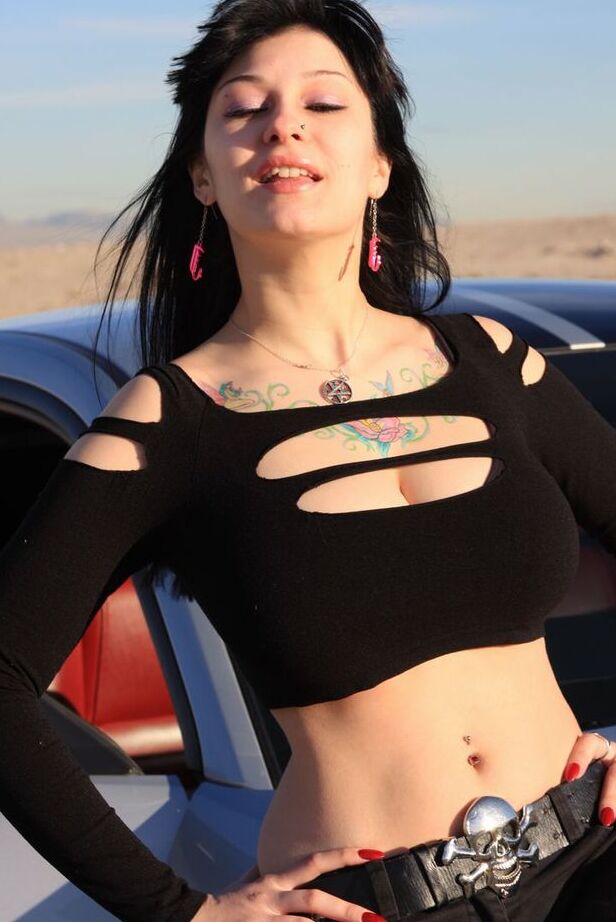 20P Brunette amateur Susy Rocks models by a muscle car during a safe for work gig