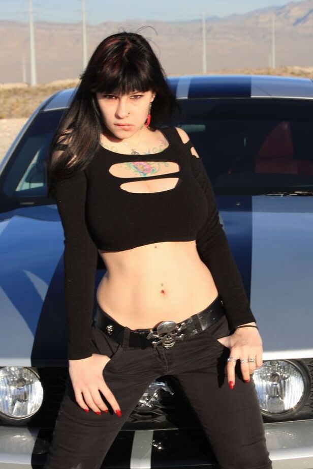 20P Brunette amateur Susy Rocks models by a muscle car during a safe for work gig