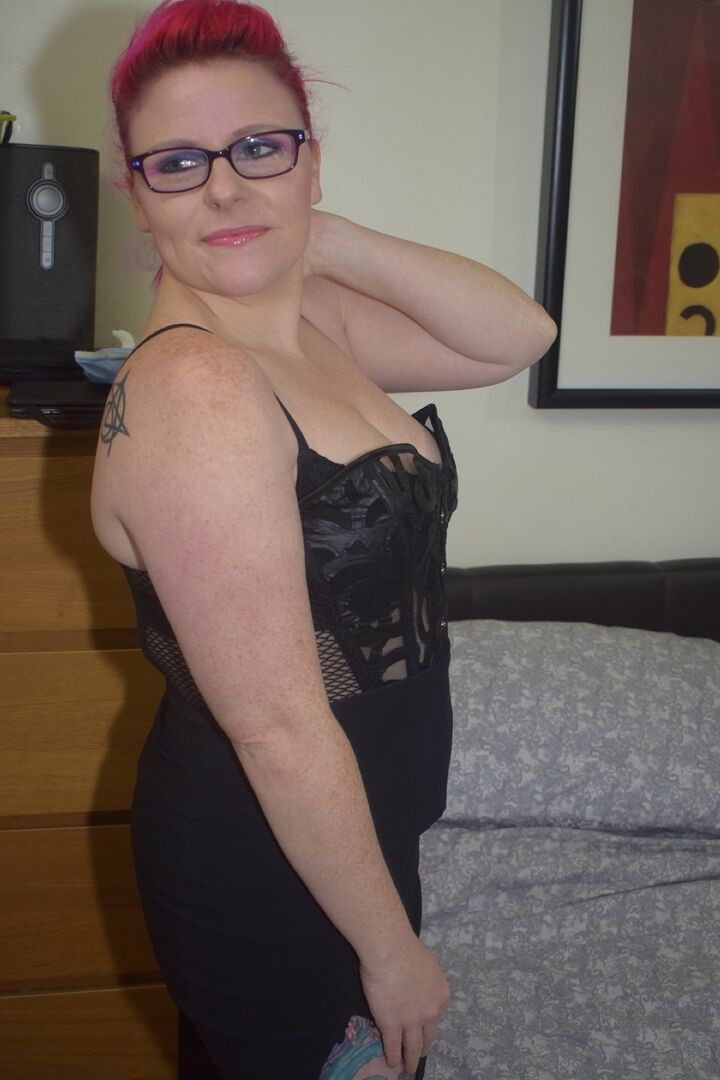 10P A ruiva tatuada Mollie Foxxx consola sua vagina em uma cama de óculos e salto alto