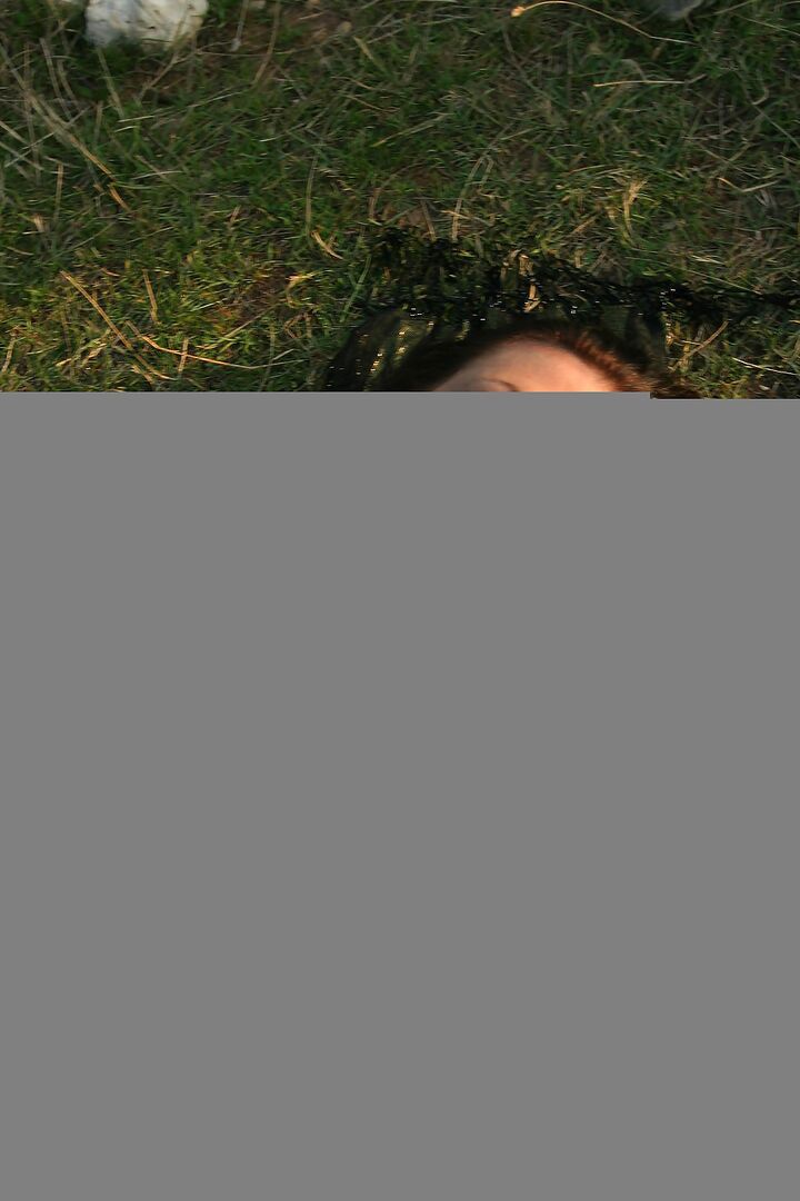 11P Solo model Kora Kryk displays her large breasts on barren grounds