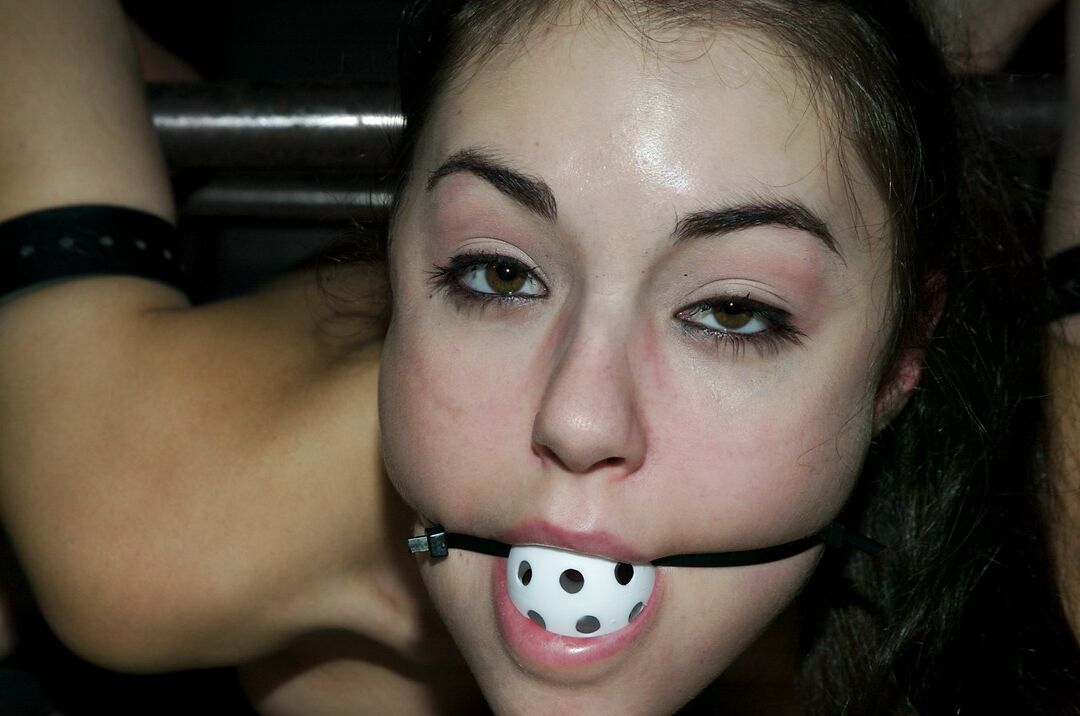 17P Ball gagged brunette Sasha Grey is masturbated while affixed to table