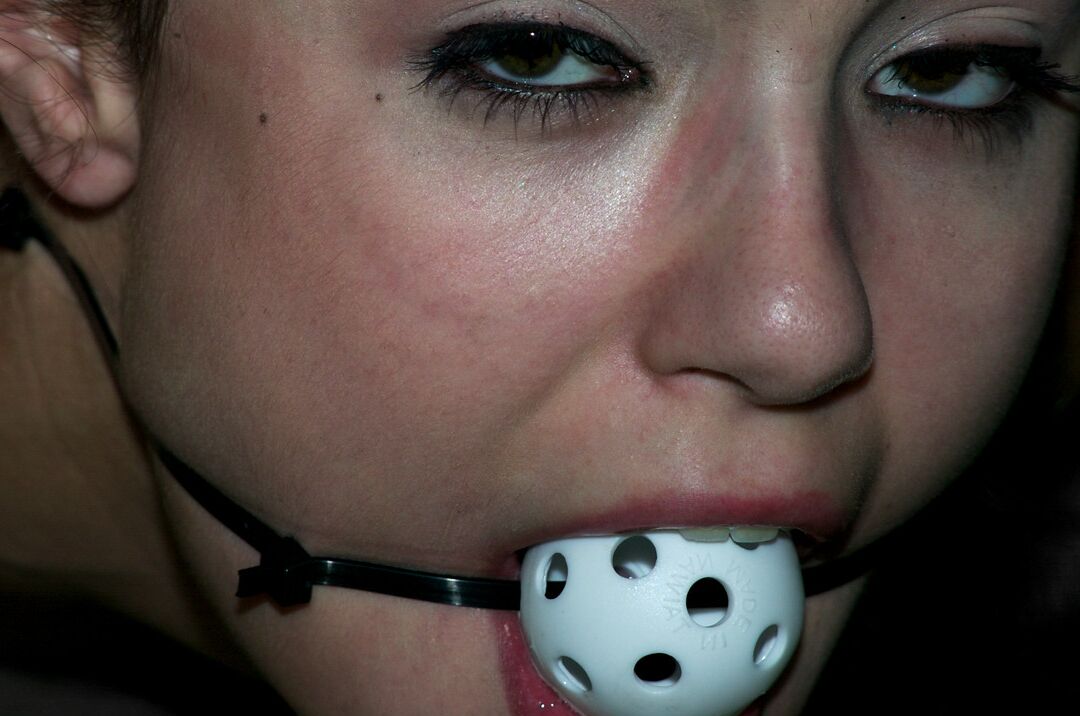 17P Ball gagged brunette Sasha Grey is masturbated while affixed to table