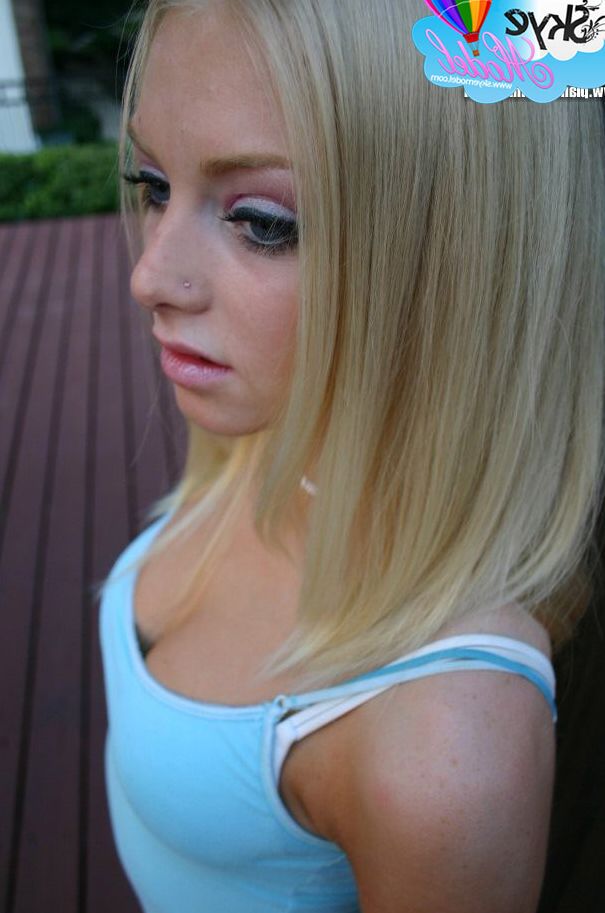 12P Blonde amateur Skye Model flashes an upskirt butt cheek on the back patio