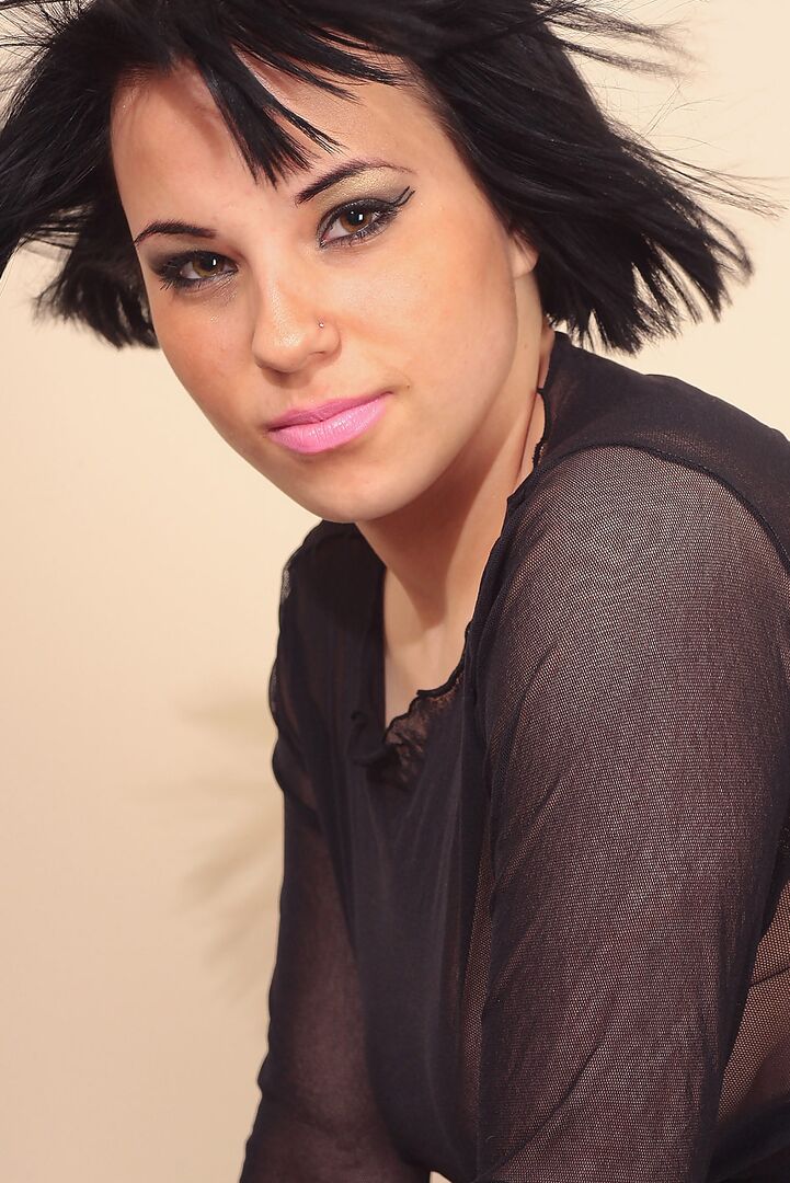 16P Dark haired girl Dora slips leather pants over thong in a see thru crop top