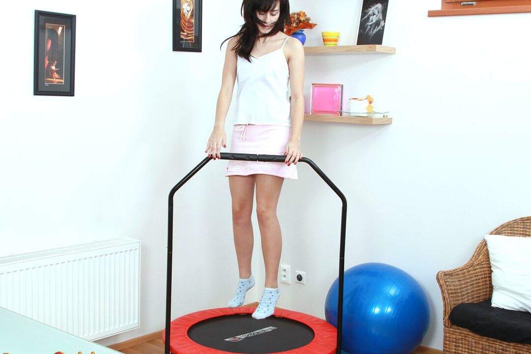 15P Young looking brunette fingers her tight pussy while bouncing on trampoline