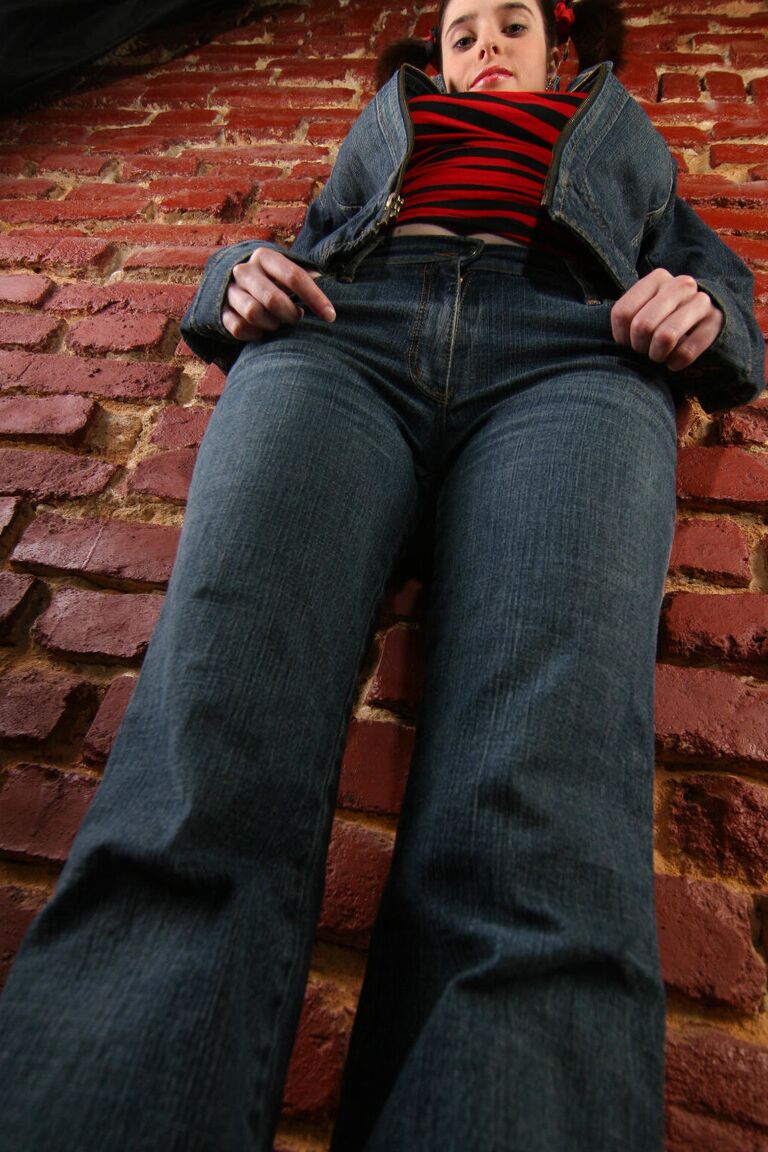 16P Busty amateur strips to her shoes against a brick wall while in pigtails